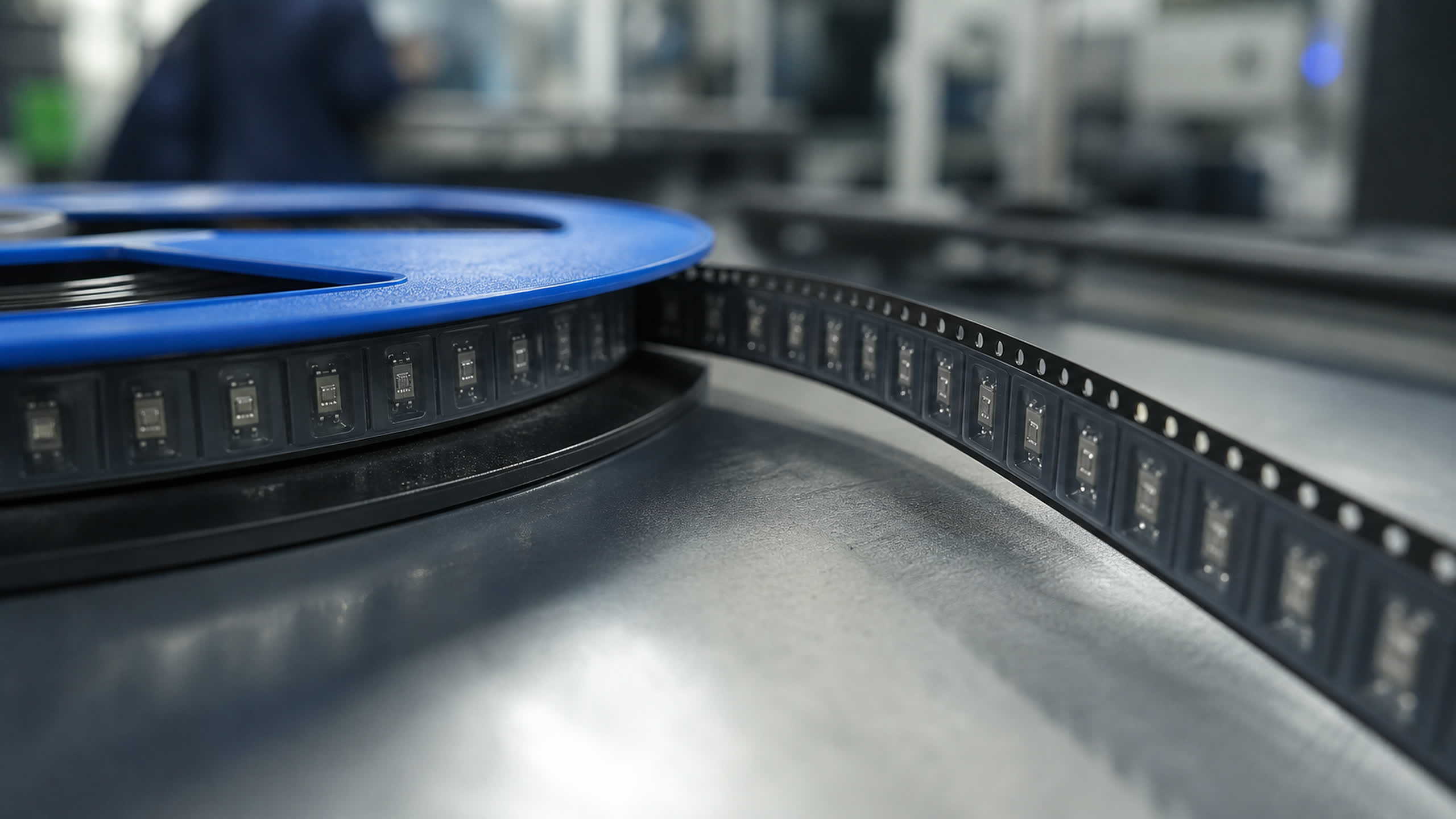 A serialized asset label being checked against the packing record before a unit is boxed.